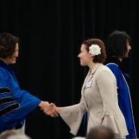 Student shaking hands with Fatma